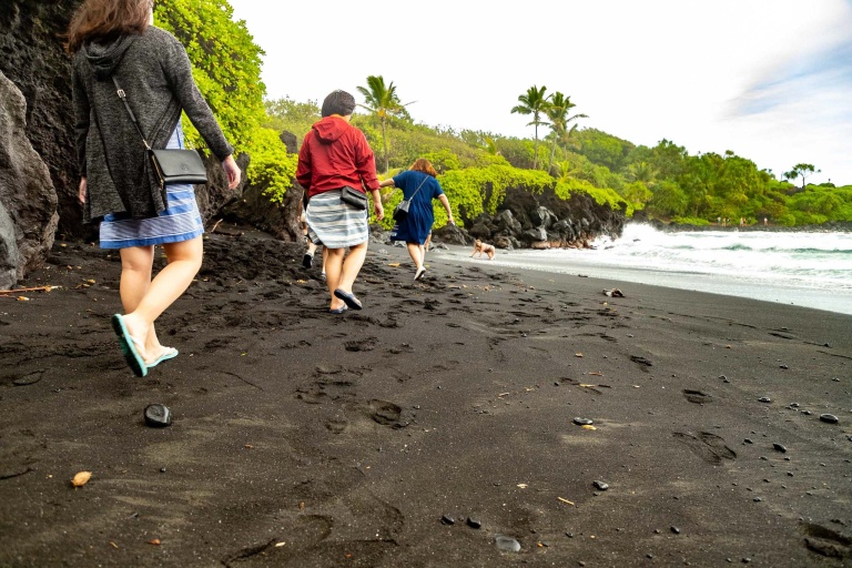 black sand beach visitors walking waianapanapa road to hana maui