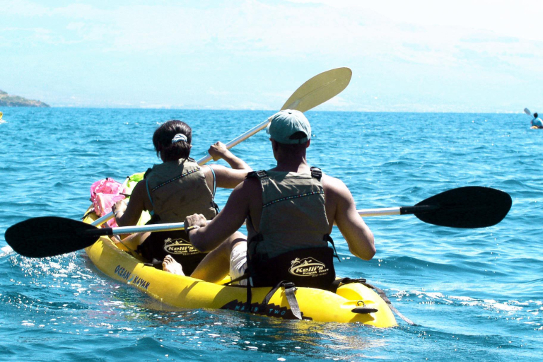 couple kayak along mauis rugged coastline
