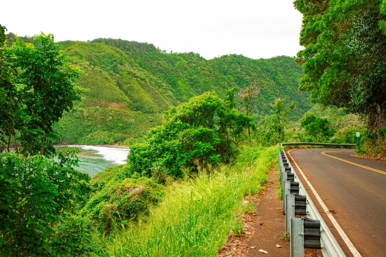 the road winds its way down the coast of east maui