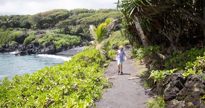 black sand beach sea cave sand road