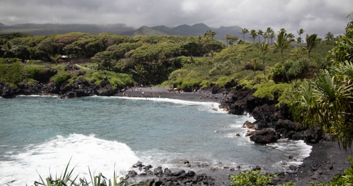 black sand beach sea cave shore